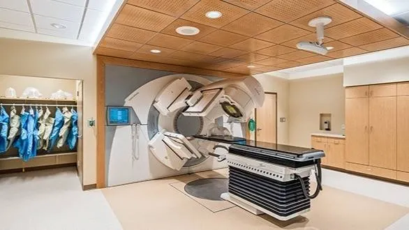 A linear accelerator in its treatment room — the machine a LINAC bunker is planned around.