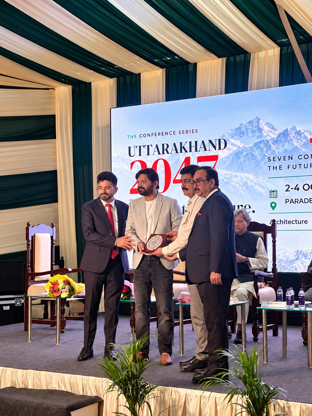 Ar. Rahul Saxena receives the Guest of Honour plaque as a panelist on stage at Uttarakhand 2047, the conference series at ARCHEX Dehradun Expo 2026.