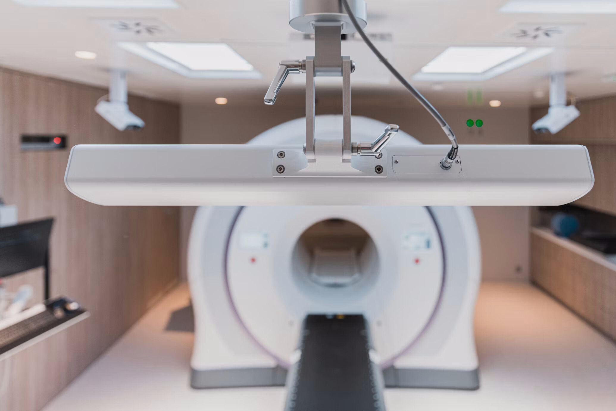 Sectional diagram of a PET-CT department showing the one-directional route from reception through injection and uptake to the shielded scanner room.